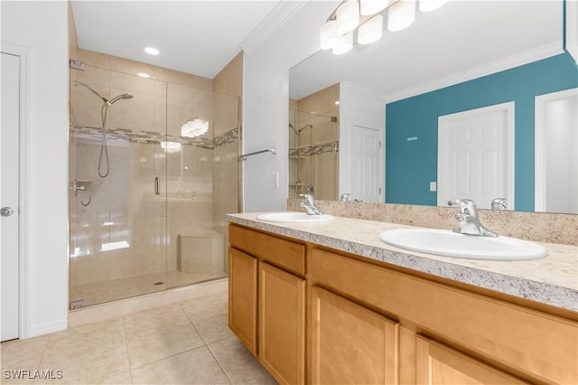 bathroom featuring tile patterned floors, vanity, a shower with shower door, and ornamental molding