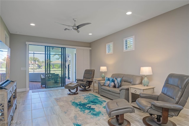 living room featuring ceiling fan and light tile patterned floors