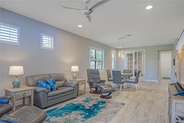 living room featuring ceiling fan and french doors