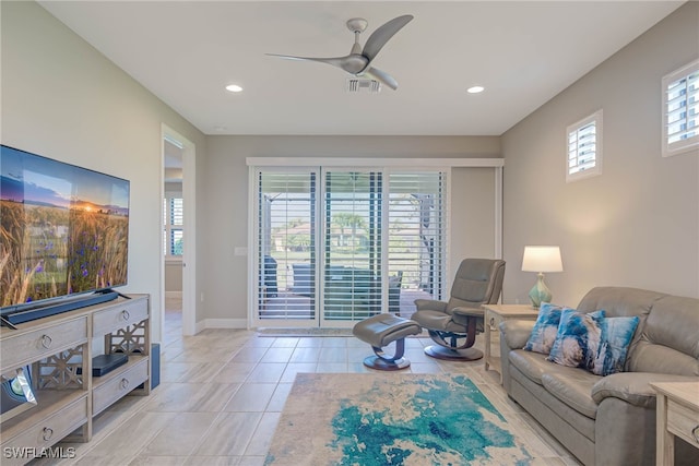 living room with ceiling fan and light tile patterned floors