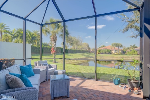 sunroom featuring a water view