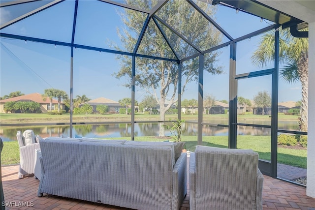 view of patio / terrace with glass enclosure and a water view