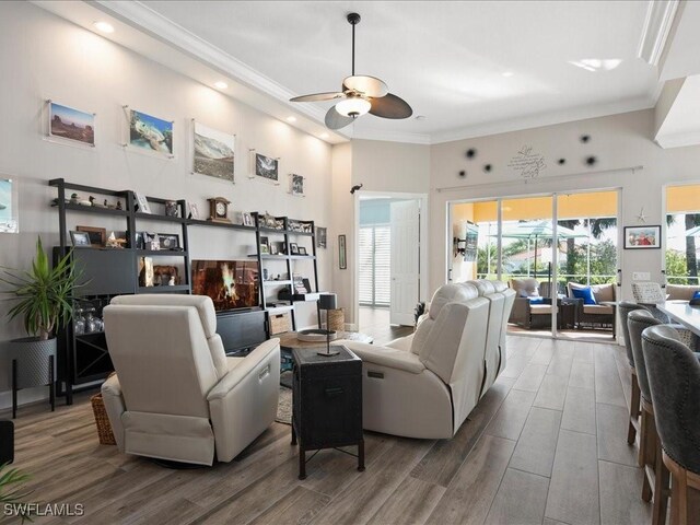 living room with hardwood / wood-style floors and ceiling fan