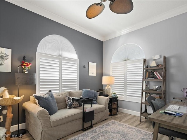 living room with ceiling fan, light hardwood / wood-style flooring, and crown molding