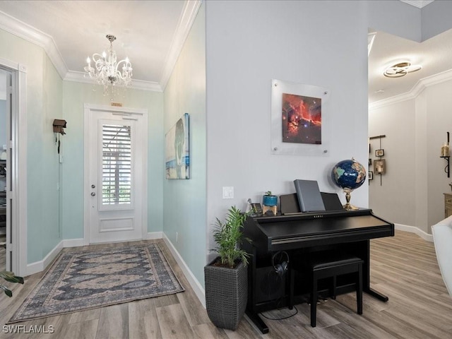 entryway with light wood-type flooring, crown molding, and a chandelier