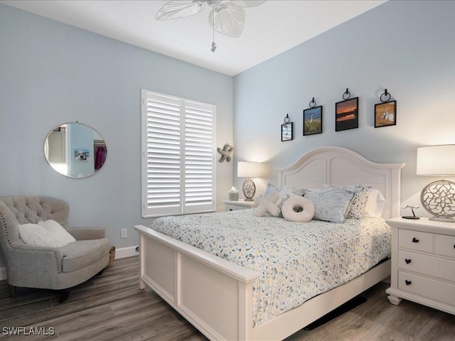 bedroom with ceiling fan and dark hardwood / wood-style floors