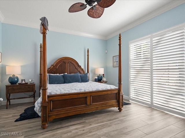 bedroom featuring ceiling fan, light hardwood / wood-style flooring, and ornamental molding