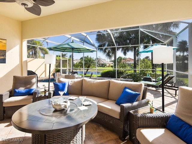 view of patio featuring ceiling fan, an outdoor hangout area, and glass enclosure