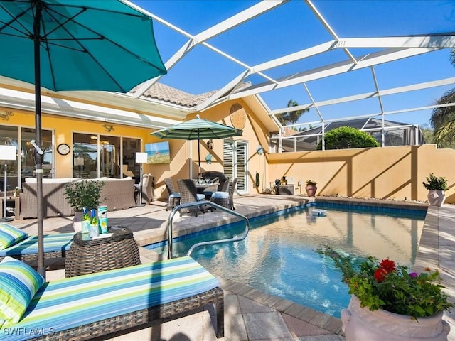 view of swimming pool featuring a lanai, an outdoor living space, and a patio area