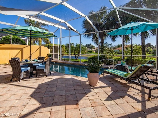 view of swimming pool with a lanai, a patio, and a water view