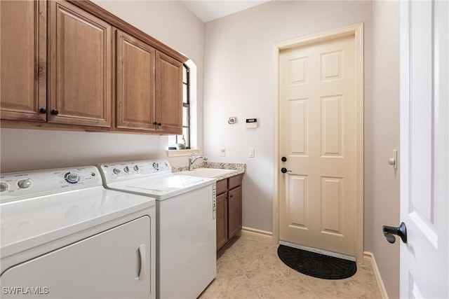 washroom featuring cabinets, light tile patterned floors, independent washer and dryer, and sink