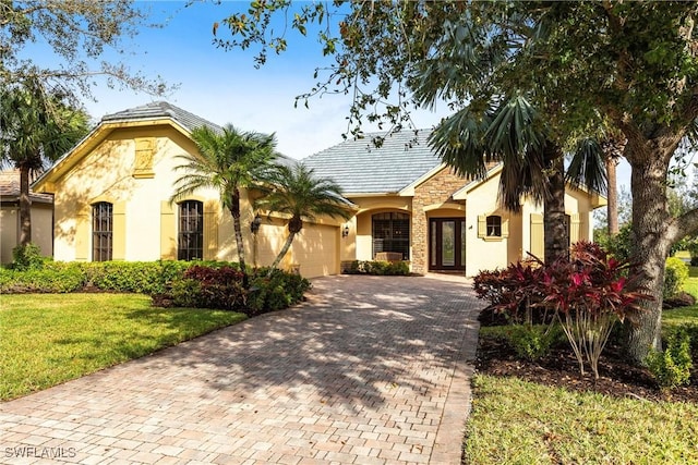 view of front of property featuring a garage and a front lawn