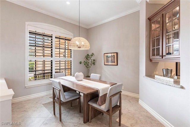 dining area featuring light tile patterned floors, a wealth of natural light, ornamental molding, and an inviting chandelier