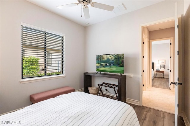 bedroom with ceiling fan and dark hardwood / wood-style floors