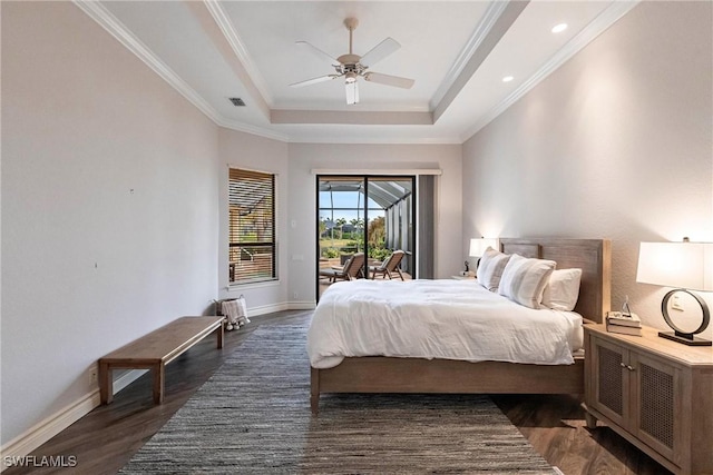 bedroom with ceiling fan, access to exterior, a tray ceiling, and dark wood-type flooring