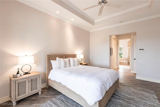 bedroom featuring ceiling fan, dark hardwood / wood-style floors, a raised ceiling, ornamental molding, and connected bathroom