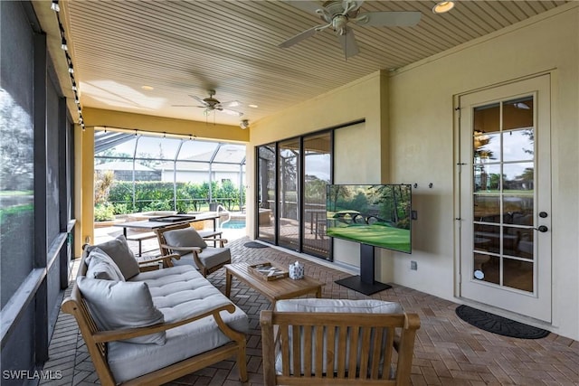 sunroom with ceiling fan and wooden ceiling