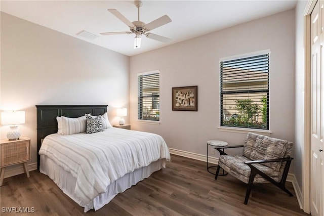 bedroom with ceiling fan, dark hardwood / wood-style flooring, and a closet