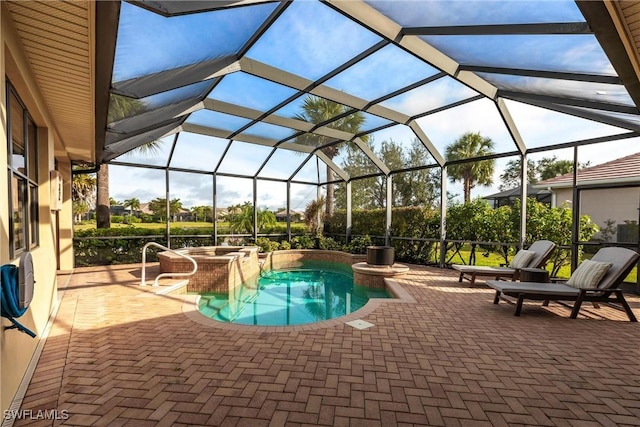 view of pool with an in ground hot tub, a lanai, and a patio