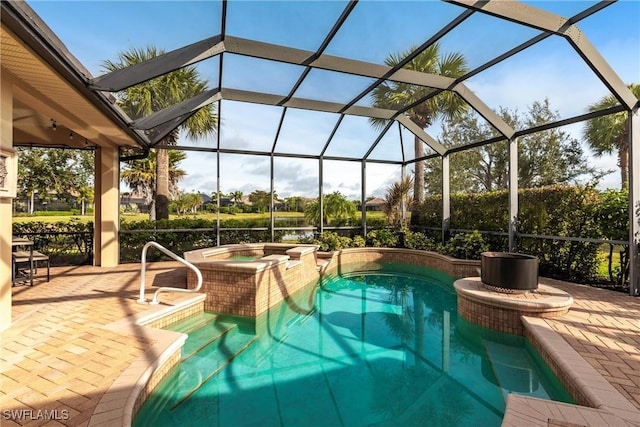 view of pool featuring an in ground hot tub, a lanai, and a patio area