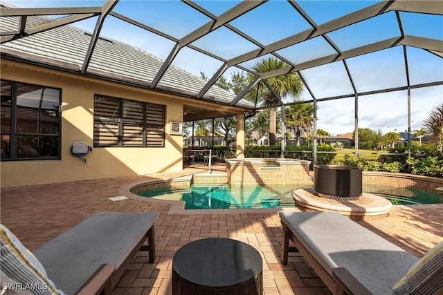 view of pool with a lanai, a patio area, and an in ground hot tub