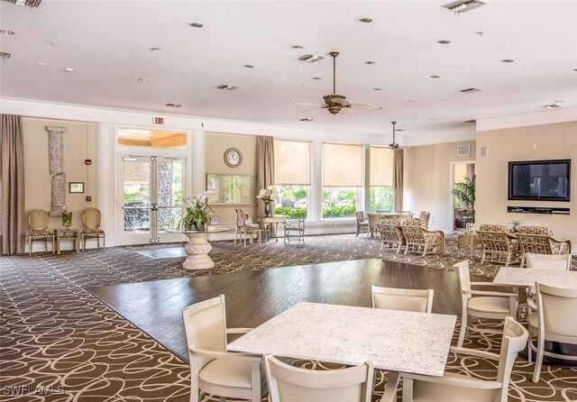 kitchen with ceiling fan, crown molding, a wealth of natural light, and a breakfast bar area