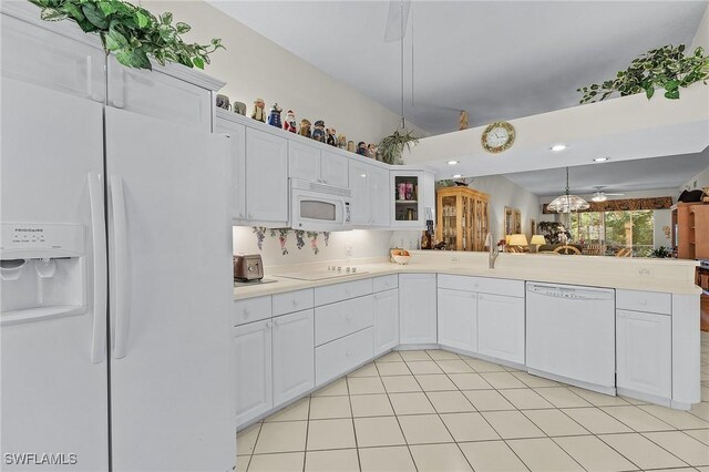 kitchen with white appliances, light tile patterned floors, tasteful backsplash, white cabinetry, and sink