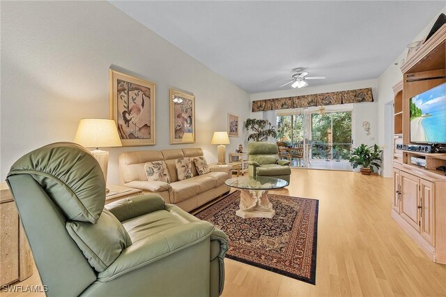 living room featuring ceiling fan and light wood-type flooring