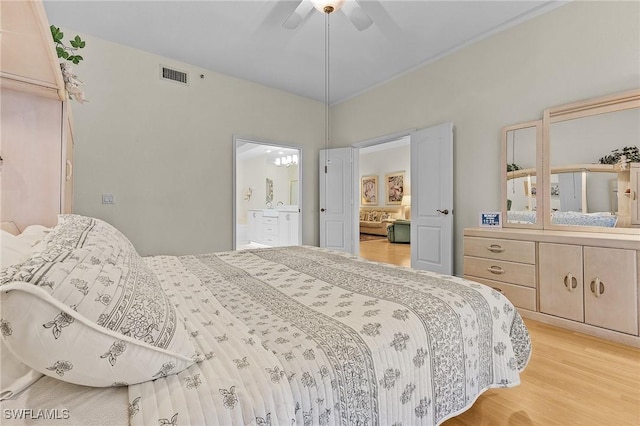 bedroom featuring ensuite bath, light wood-type flooring, and ceiling fan