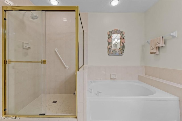 bathroom featuring separate shower and tub