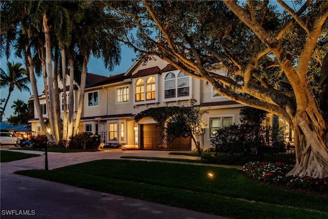 view of front of property featuring a garage and a front yard