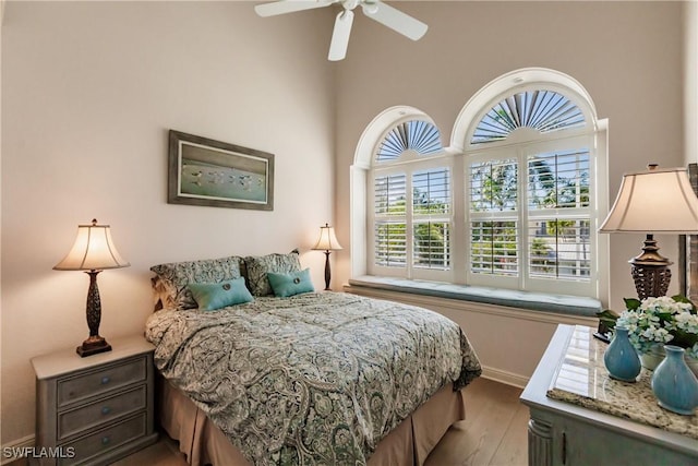 bedroom with ceiling fan and light hardwood / wood-style flooring