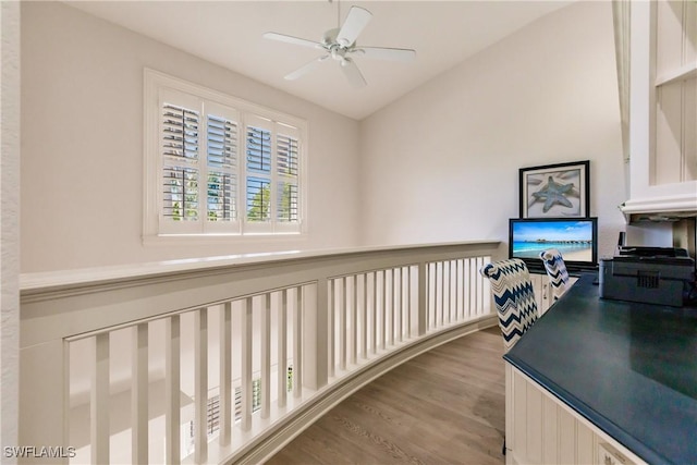 home office featuring vaulted ceiling, light hardwood / wood-style floors, and ceiling fan