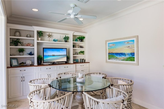 dining space with ornamental molding and ceiling fan