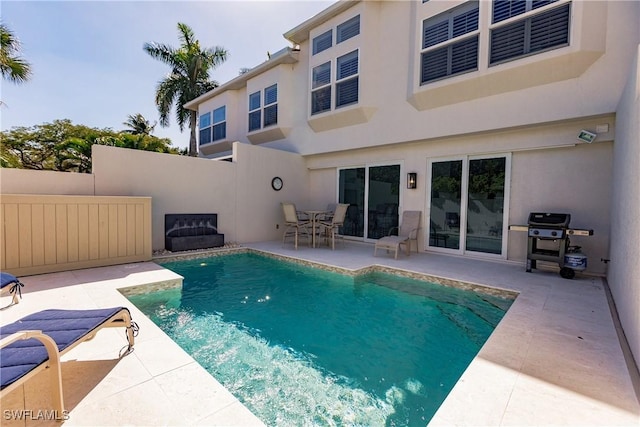 view of pool featuring a patio and grilling area