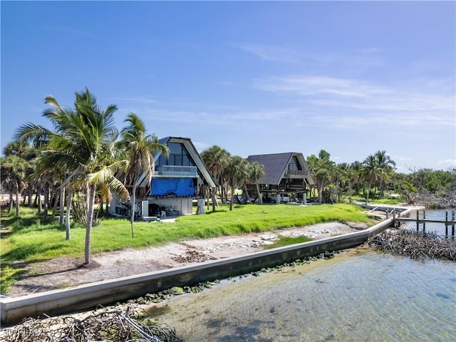 exterior space with a lawn and a water view