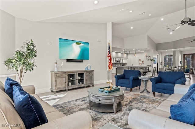 tiled living room featuring ceiling fan and vaulted ceiling