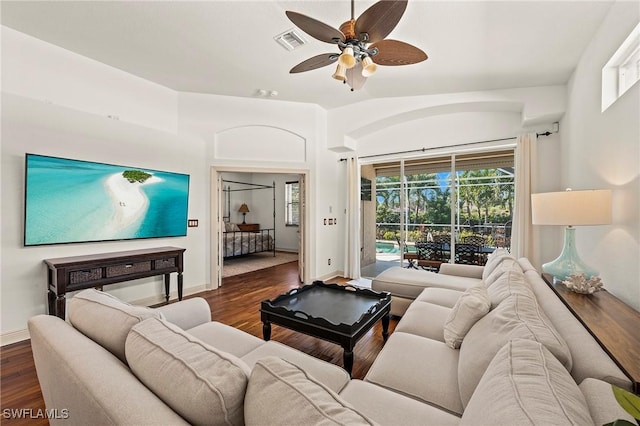 living room featuring ceiling fan, plenty of natural light, and dark hardwood / wood-style floors