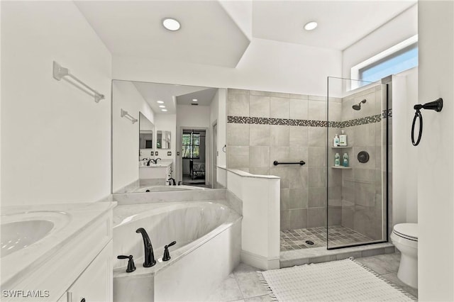 full bathroom featuring vanity, tile patterned flooring, and shower with separate bathtub