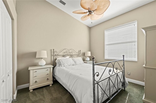 carpeted bedroom featuring ceiling fan, a closet, and vaulted ceiling