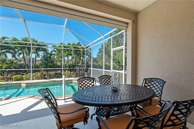 view of swimming pool featuring a lanai and a patio area