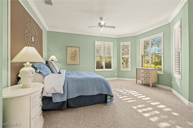 carpeted bedroom featuring ceiling fan and ornamental molding