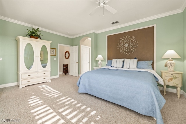 bedroom featuring ceiling fan, ornamental molding, and carpet floors