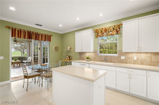 kitchen with sink, white cabinets, and a center island