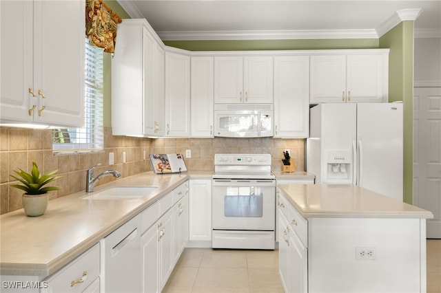 kitchen with white cabinetry, sink, a center island, and white appliances