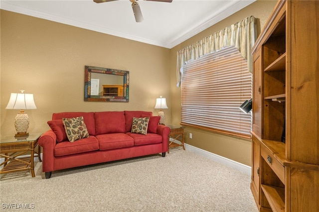 living room featuring ceiling fan, crown molding, and carpet floors