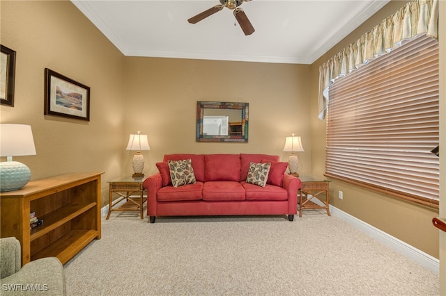 carpeted living room with ceiling fan and crown molding