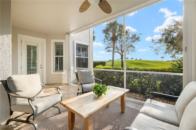 sunroom featuring ceiling fan