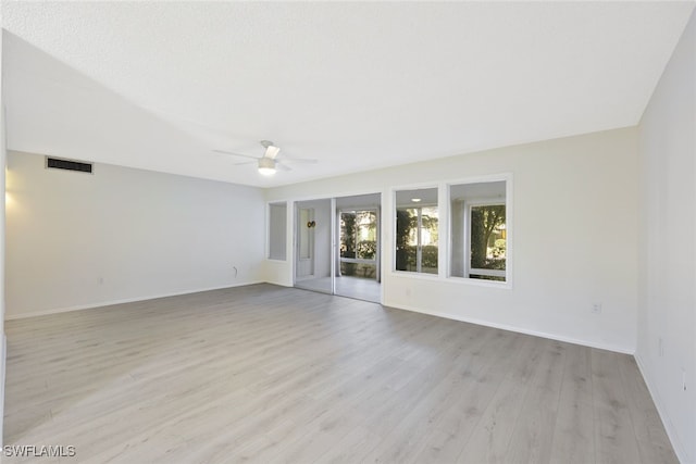 empty room featuring light hardwood / wood-style flooring and ceiling fan