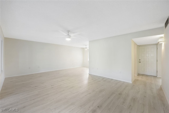 spare room with light wood-type flooring and ceiling fan